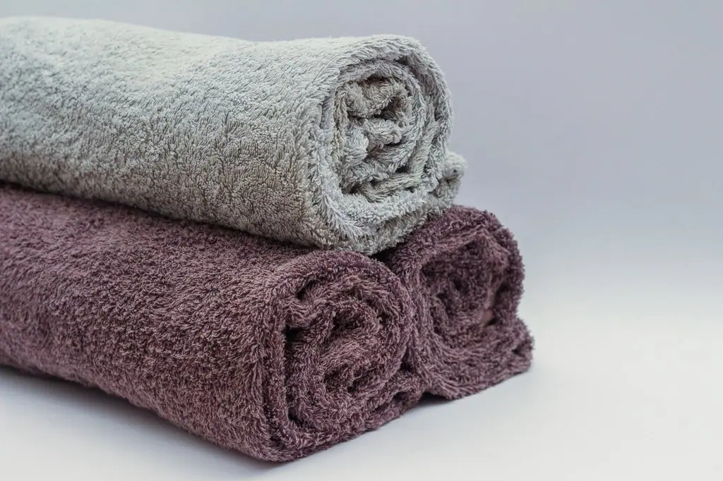 Rolled towels in grey and plum